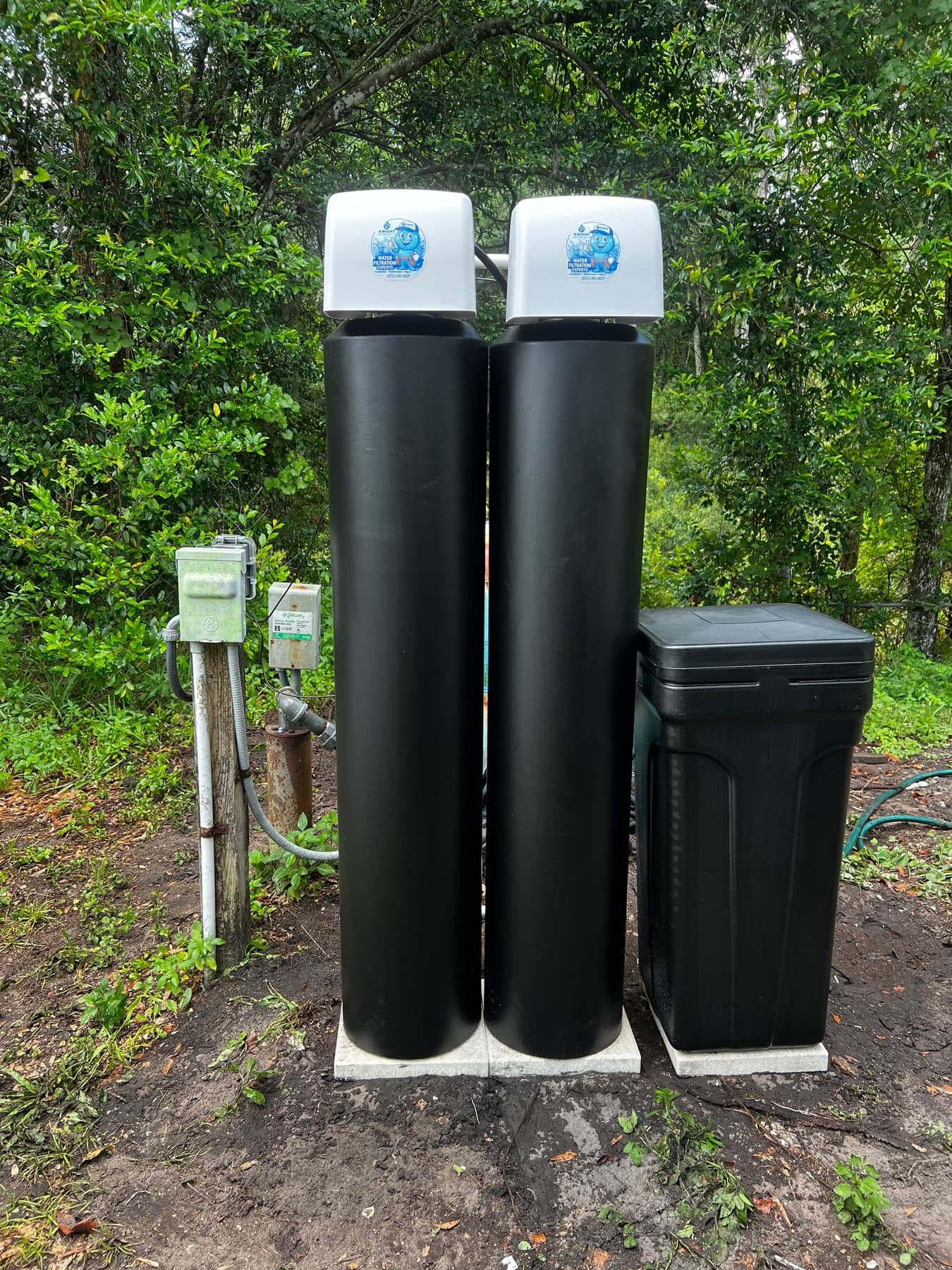 Whole-house water softener and filtration system installed outdoors for a Florida private well