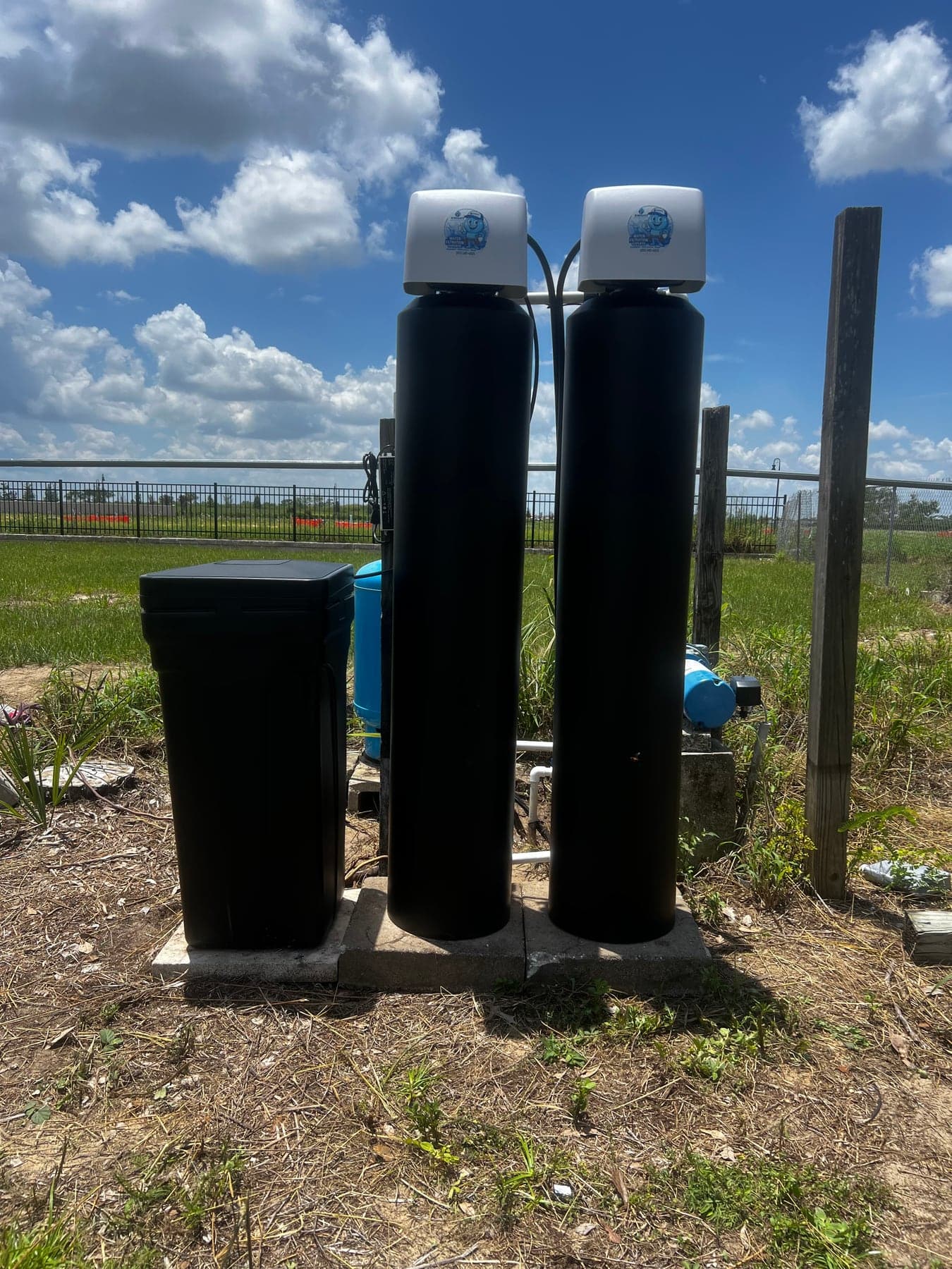 Outdoor water softener and filtration system installed near Florida well equipment